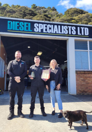 Dylan Bennett with Business Owners Jared and Alana Watkins, and dog, Millie.