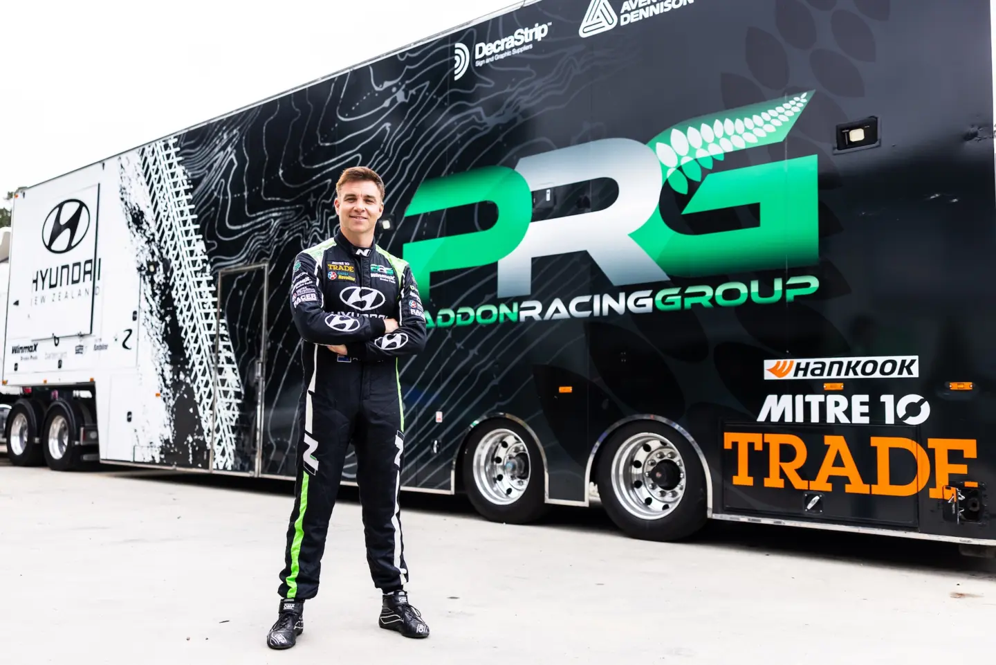 Hayden Paddon standing in front of Paddon Racing Group truck
