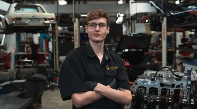 Blake Martin standing in the Autohaus workshop in Auckland with his arms folded