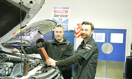 Alex Gill working on a car