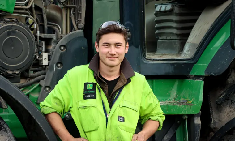 Connor Hall standing in front of a vehicle, at work